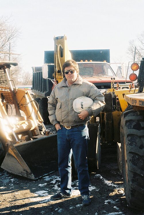 Greg Opp at Opp Construction Job Site in 1978 Greg Opp in 1978 standing beside concrete paving equipment at an Opp Construction jobsite in North Dakota
